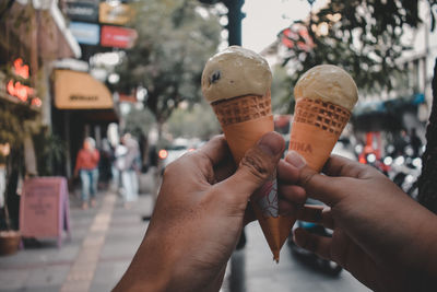 Midsection of person holding ice cream