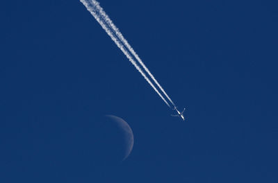 Low angle view of vapor trail in blue sky