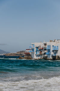 View of the old houses in little venice, mykonos town, mykonos, greece, over the augean sea.