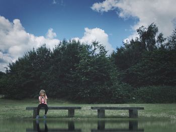 Silhouette of woman standing by lake