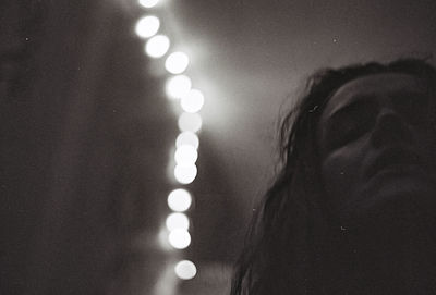 Close-up portrait of woman with illuminated lights