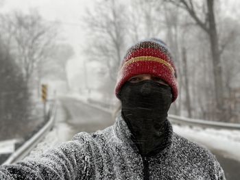 Cold queer man in snowstorm 