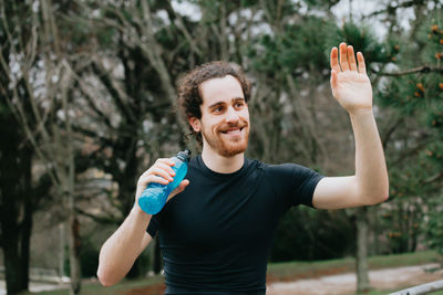 Portrait of smiling young man standing outdoors