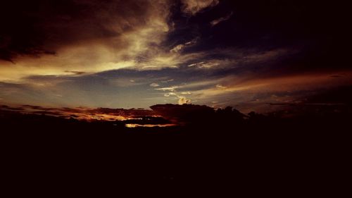 Silhouette landscape against sky during sunset