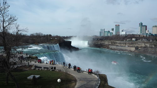 Panoramic view of people on shore against sky