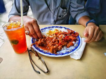 Close-up of hand holding food on table