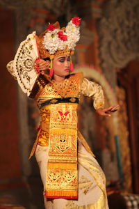 Woman in traditional clothing performing during event