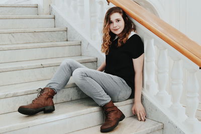 Portrait of young woman sitting outdoors