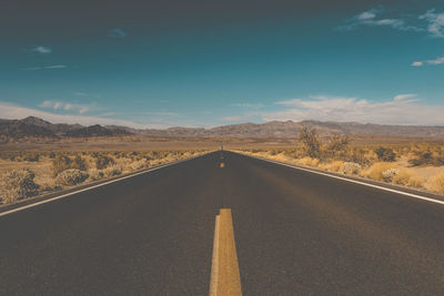 Empty road along desert landscape