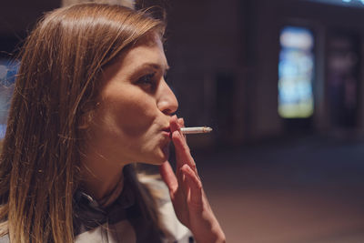 Close-up of woman smoking cigarette