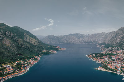 High angle view of sea and mountains against sky