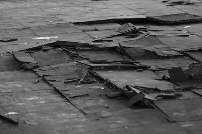 High angle view of broken wood on footpath in city