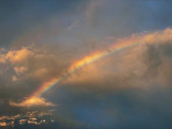 Low angle view of rainbow against sky during sunset
