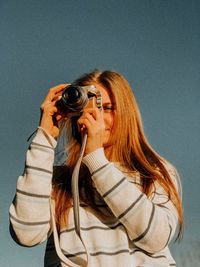 Portrait of woman photographing