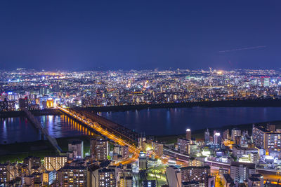 High angle view of illuminated buildings in city at night