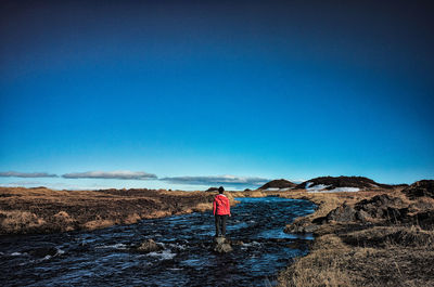 Silhouette of woman standing in water