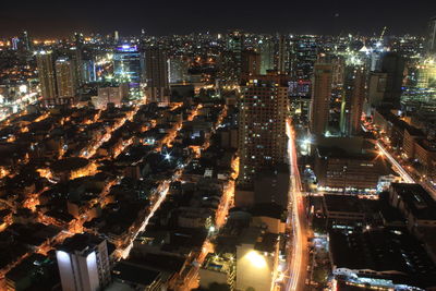 High angle view of illuminated city buildings at night