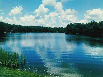 Scenic view of calm lake against cloudy sky