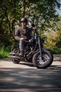 Man riding motorcycle on road