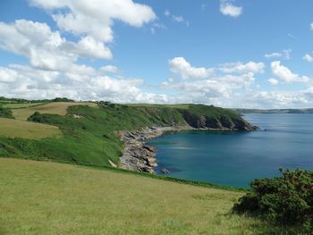 Scenic view of sea and coast against sky