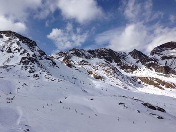 Scenic view of snow covered mountains against sky