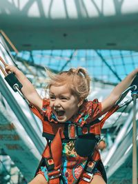 Portrait of happy girl with arms raised