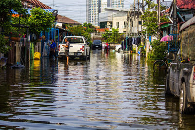 View of canal in city during rainy season