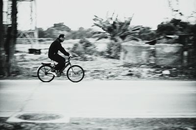 Man riding bicycle on water