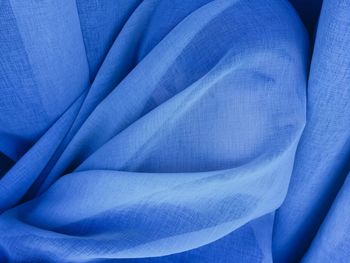 Close-up of woman covered in blue fabric