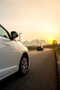 Car on road at sunset