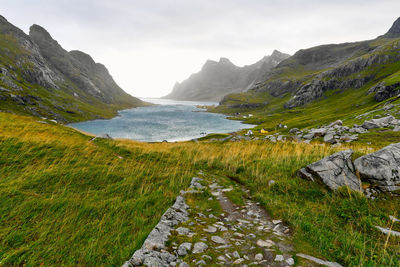 Hiking trail leading to remote village vinstad at the coast and mountains in lofoten norway