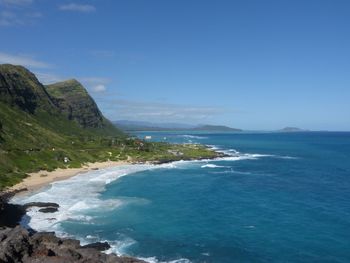 Scenic view of sea and mountains against sky