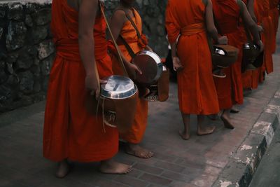 Rear view of people walking on street