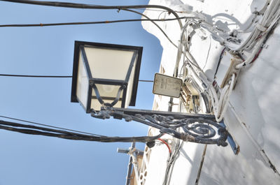 Low angle view of telephone pole against sky