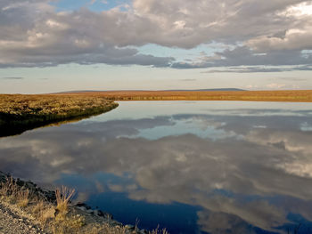 Scenic view of lake against sky during sunset