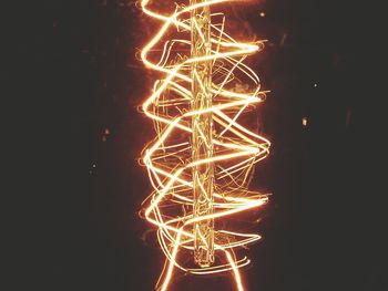 Close-up of illuminated christmas lights against black background