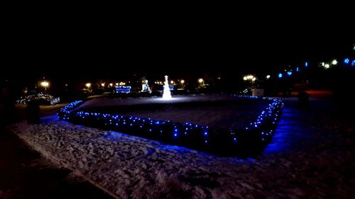 Illuminated frozen lake at night during winter