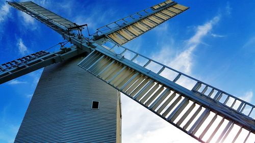 Low angle view of traditional windmill against sky