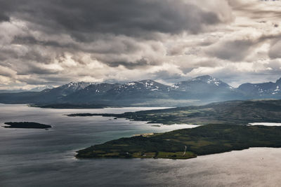 Scenic view of mountains against cloudy sky