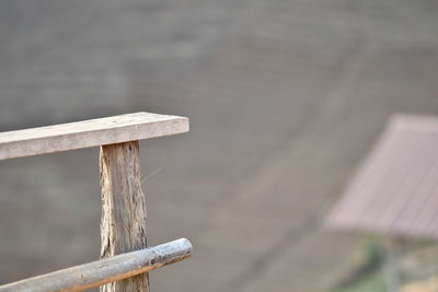 Close-up of wooden post on railing