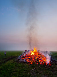 Bonfire on field against sky