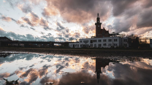 Reflection of building in lake during sunset