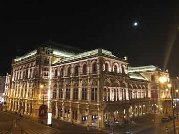 Low angle view of building lit up at night