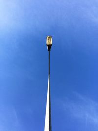 Low angle view of street light against blue sky