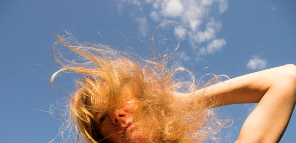 Low angle view of woman against sky