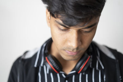 Close-up portrait of young man against white background