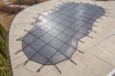 In the ground pool has been winterized with a pool cover