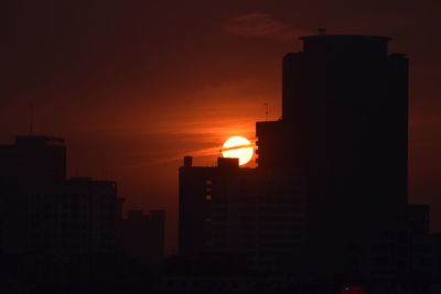 Silhouette of city during sunset