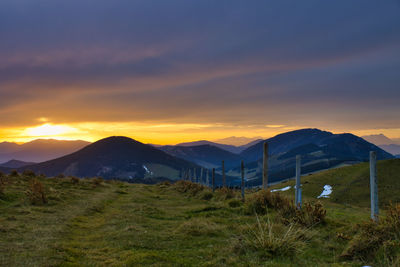 Scenic view of field against sky during sunset