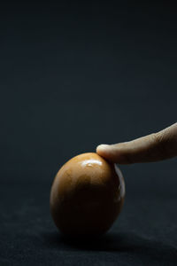 Close-up of apple on table against black background